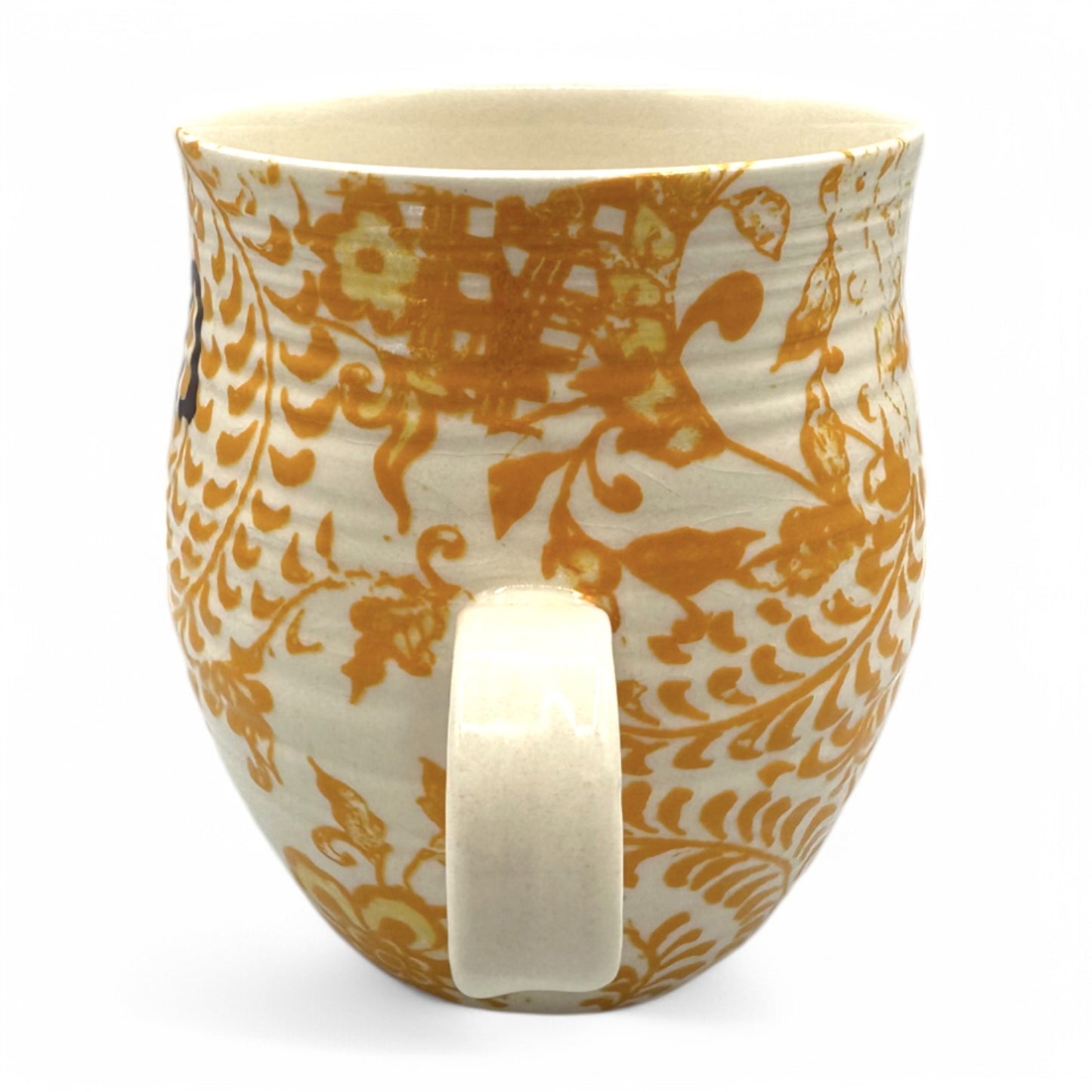 Anthropologie Mug with Initial H features a floral design in beige, yellow, and brown; curved Chinios style.