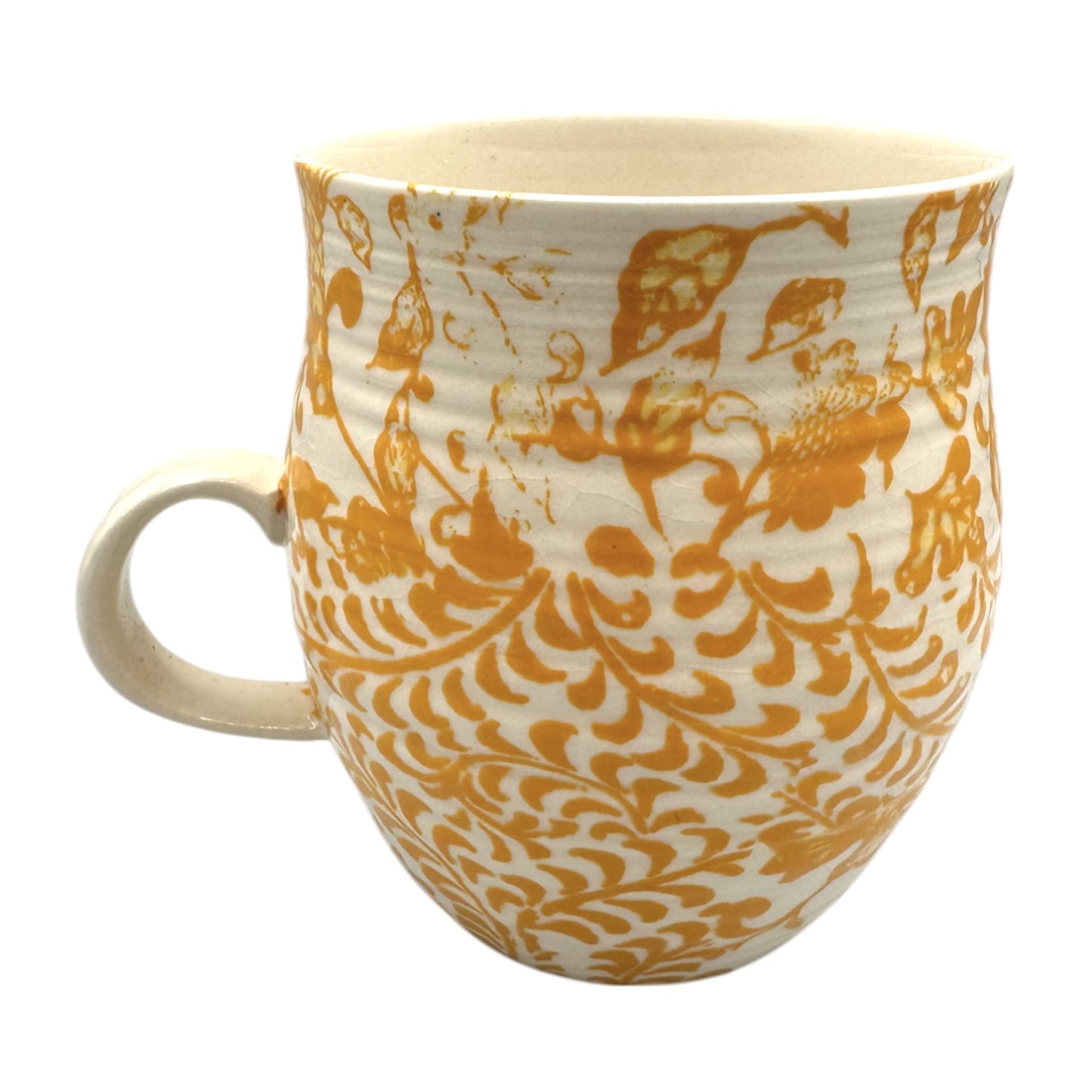 Curved Anthropologie mug featuring Initial H in floral design, beige, yellow, and brown with light crazing details.