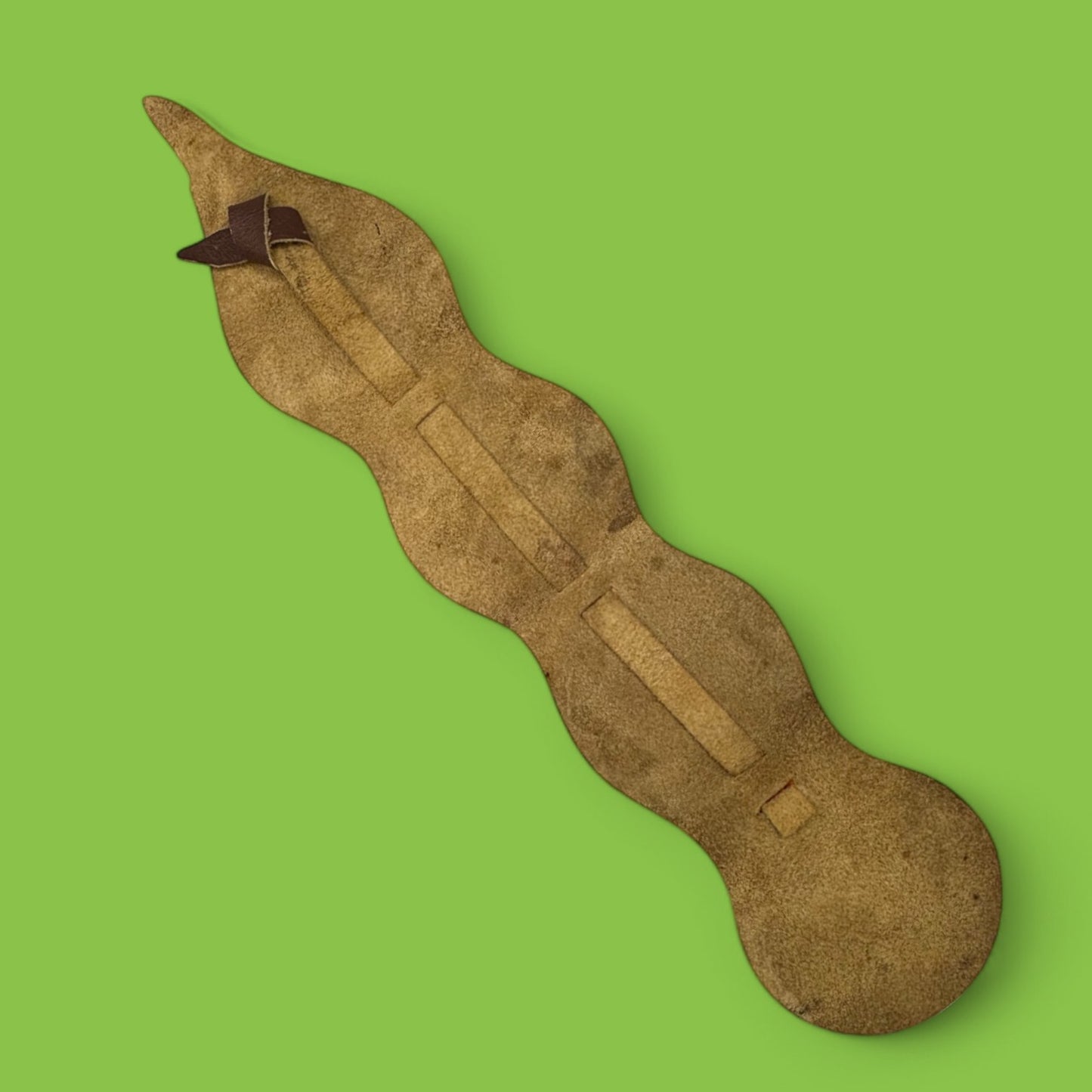 Brass horse ornament on leather strap featuring African animals like water buffalo and elephant, perfect for decor.