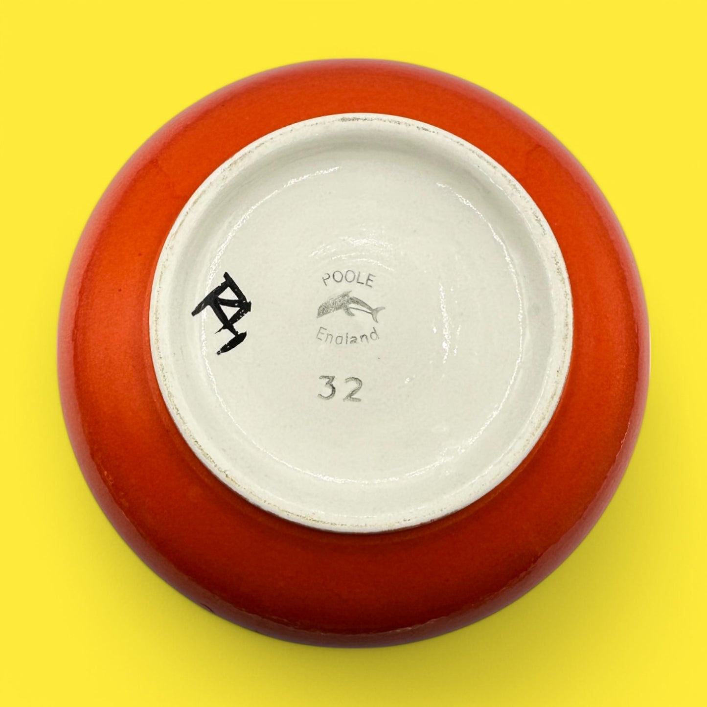 Poole pottery number 32 onion vase featuring the signature stamp and vibrant orange glaze, designed by Robert Jefferson.