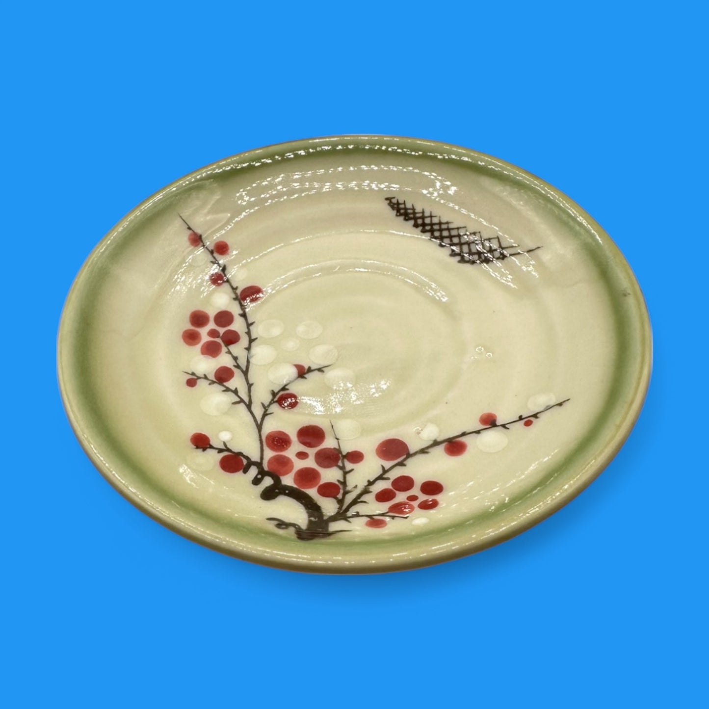 Vintage Japanese Celadon Dish - Plum Blossom Design features a delicate green glaze and vibrant hand-painted blooms.