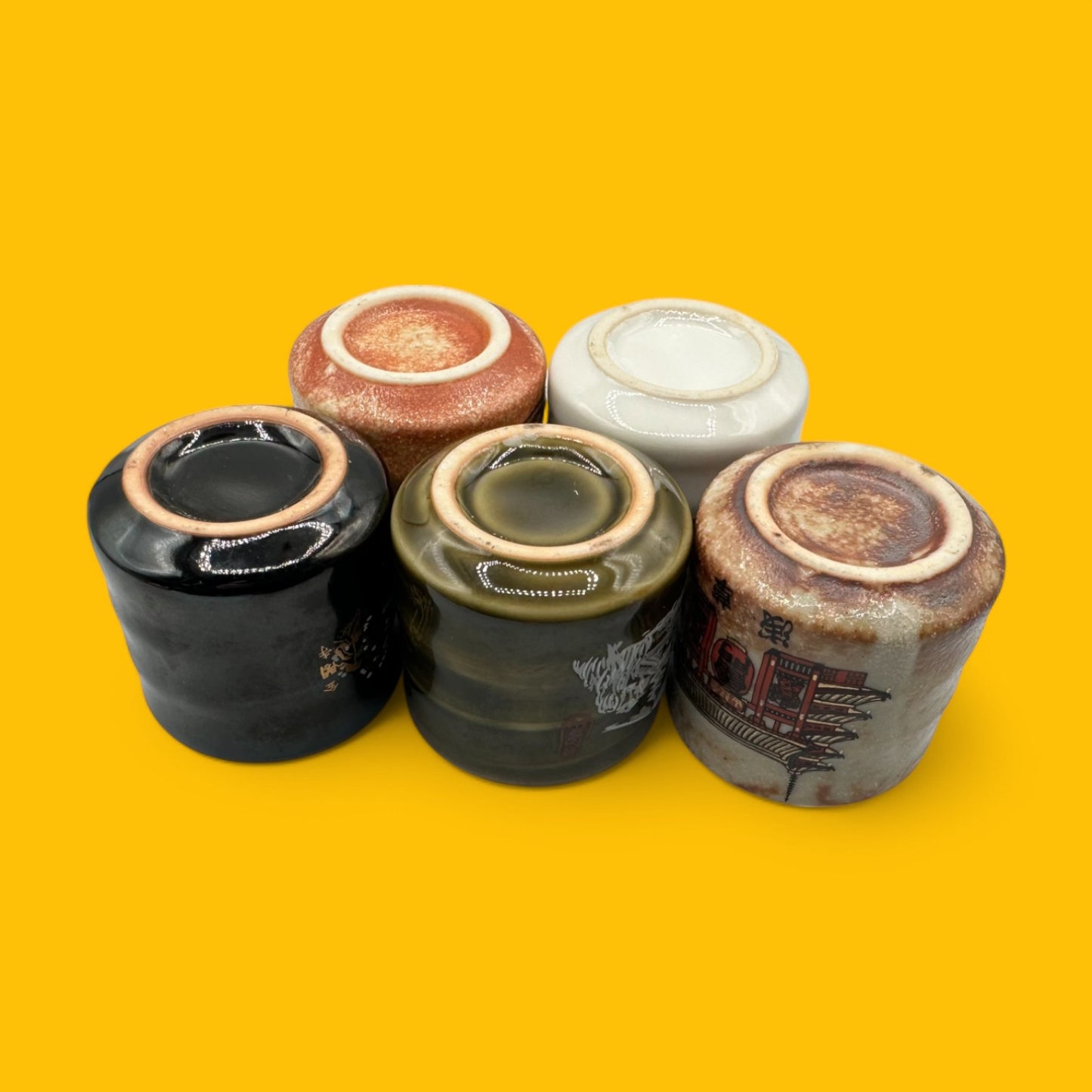 Set of 5 Traditional Japanese Ceramic Tea Cups featuring unique designs, perfect for adding elegance to your tea time.