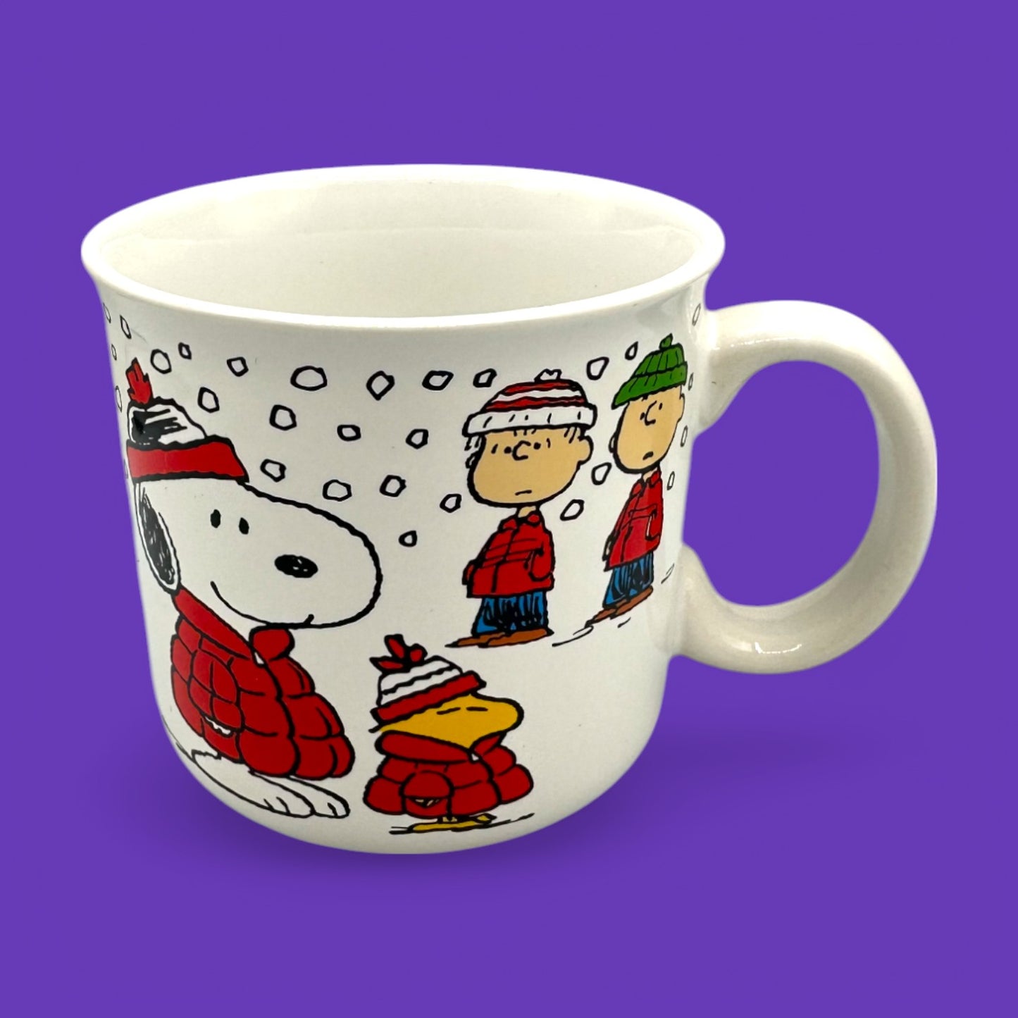 Cozy Vintage Peanuts Snoopy winter mug featuring Snoopy, Woodstock, and Charlie Brown, perfect for collectors.