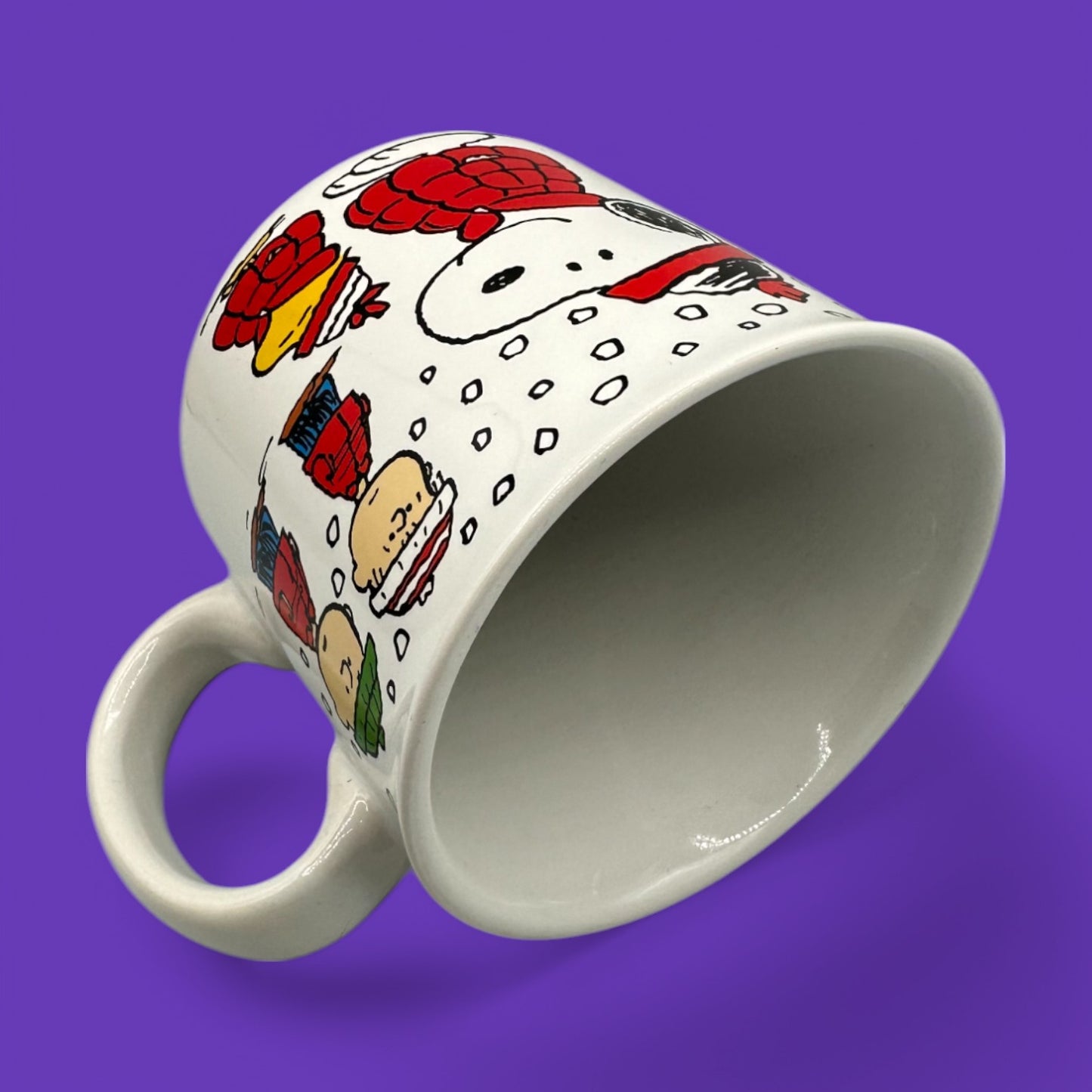 Cozy up with this Vintage Peanuts Snoopy winter mug, featuring Snoopy, Woodstock, and Charlie Brown in warm gear.