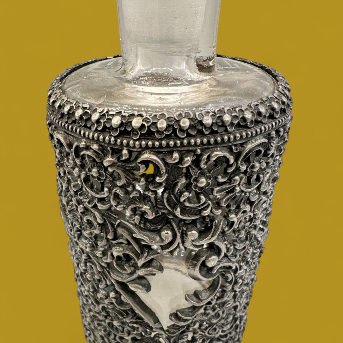 Antique ornate metal filigree perfume bottle with stopper