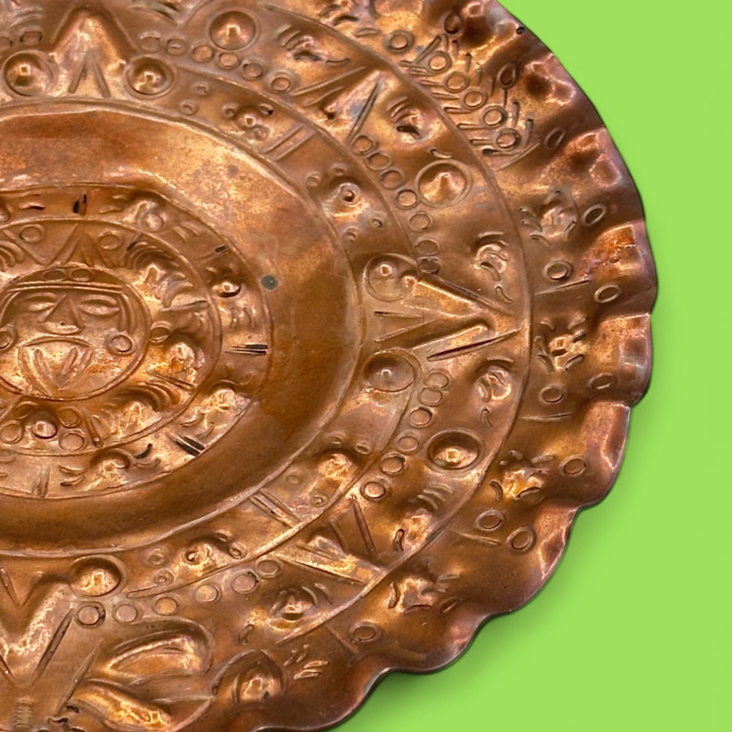 Vintage round copper plate with Aztec sun god design