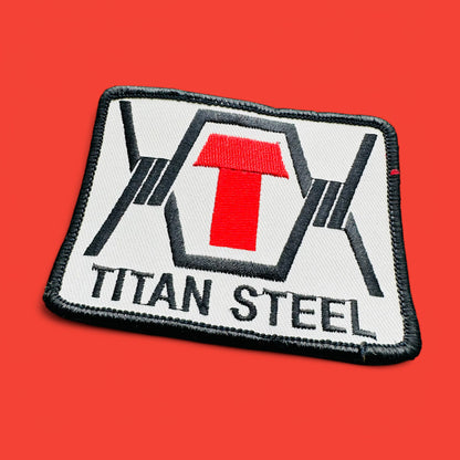 Vintage 1990's Titan Steel Embroidered Patch features black text on white with a red capital T, perfect for collectors.