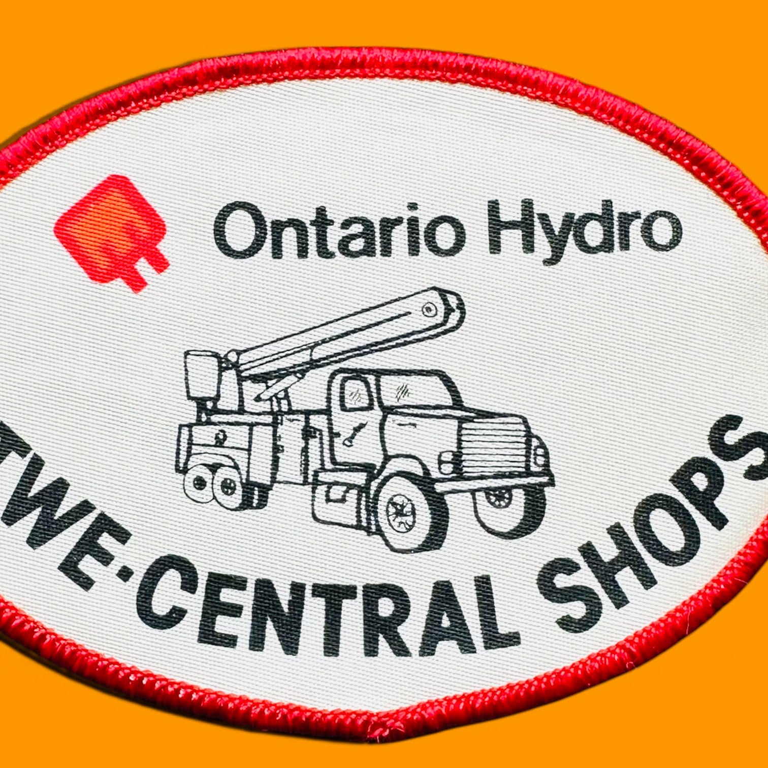 Ontario Hydro TWE-Central Shops Embroidered Patch 3" x 4" Oval Sew On features a white background and truck silhouette.