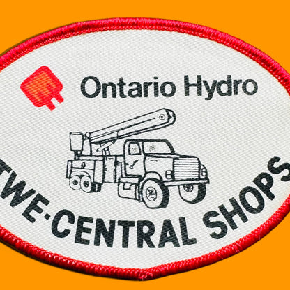 Ontario Hydro TWE-Central Shops Embroidered Patch 3" x 4" Oval Sew On features a white background and truck silhouette.