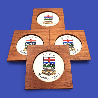 MCM 1960's Teak Drink Coaster Set | Convention: C.I.C.A Banff Alberta 1969 features elegant crests and Mid Century Modern style.