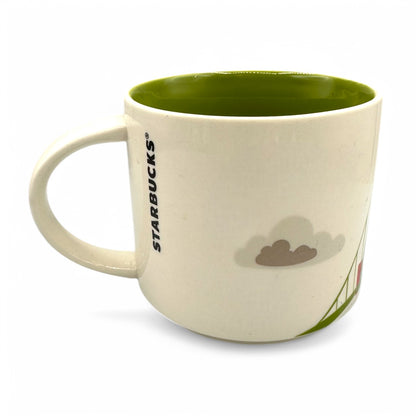 Starbucks Portland “you are here collection” mug featuring green interior, mountain motif, and iconic bridge design.