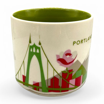 Starbucks Portland “you are here collection” mug features a mountain motif and iconic bridge design in vibrant colors.