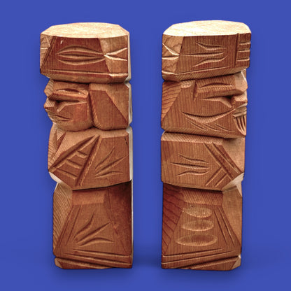 Vintage Japanese carved dolls featuring a hand-carved Ainu couple in abstract cedar wood, showcasing unique folk art.