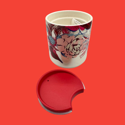 Starbucks red floral mug features a vibrant design and a red lid, perfect for holiday beverages on the go.
