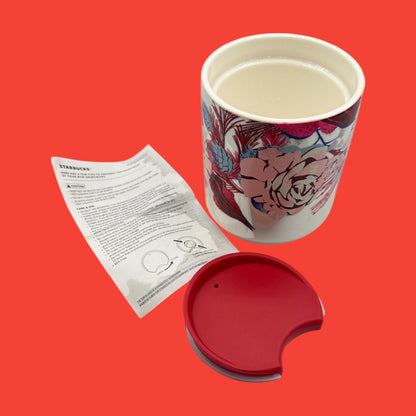 Starbucks red floral mug features vibrant floral designs and a red lid, perfect for on-the-go sipping this holiday season.