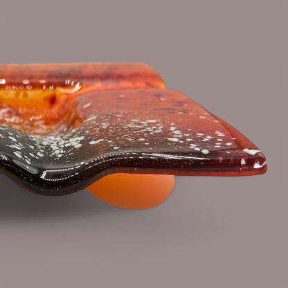 Add a pop of color to your space with this Vintage MCM Orange Fused Glass Sunburst Ashtray Decor, featuring stunning textures.