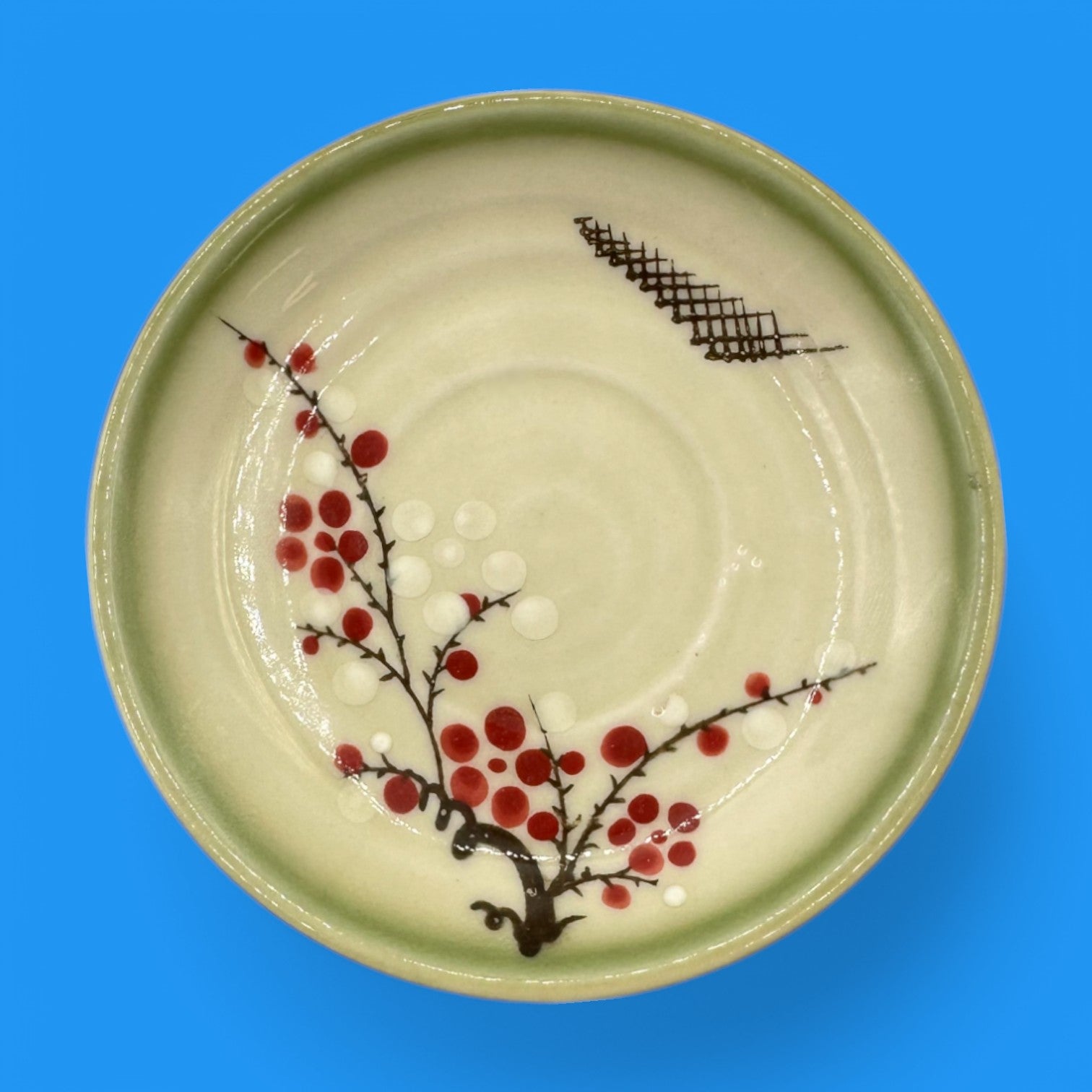 Vintage Japanese Celadon Dish - Plum Blossom Design featuring delicate green glaze and vibrant hand-painted blossoms.