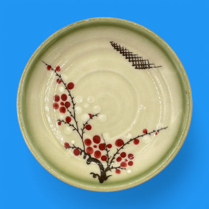 Vintage Japanese Celadon Dish - Plum Blossom Design featuring delicate green glaze and vibrant hand-painted blossoms.