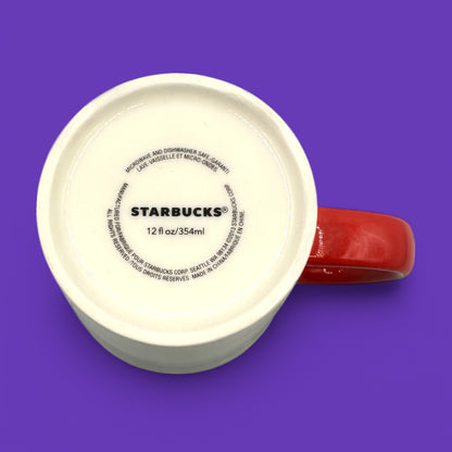 Starbucks You & Me mug showcases a white ceramic body with a vibrant red handle and bold ampersand design.