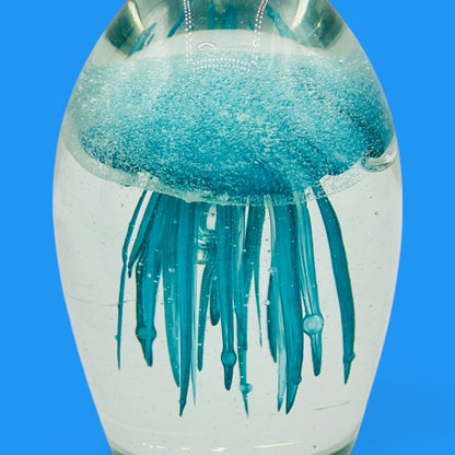 Teal Jellyfish Glass Paperweight - Vintage Charm - Glows in the Dark, showcasing a mesmerizing jellyfish in clear glass.