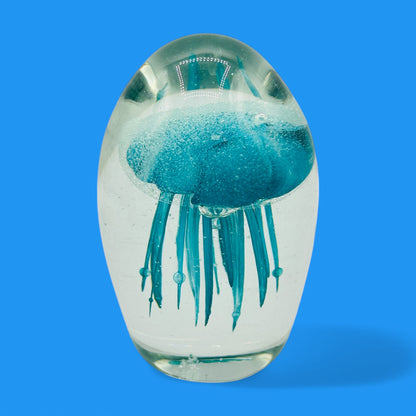 Teal Jellyfish Glass Paperweight - Vintage Charm - Glows in the Dark captures a mesmerizing underwater scene in glass.