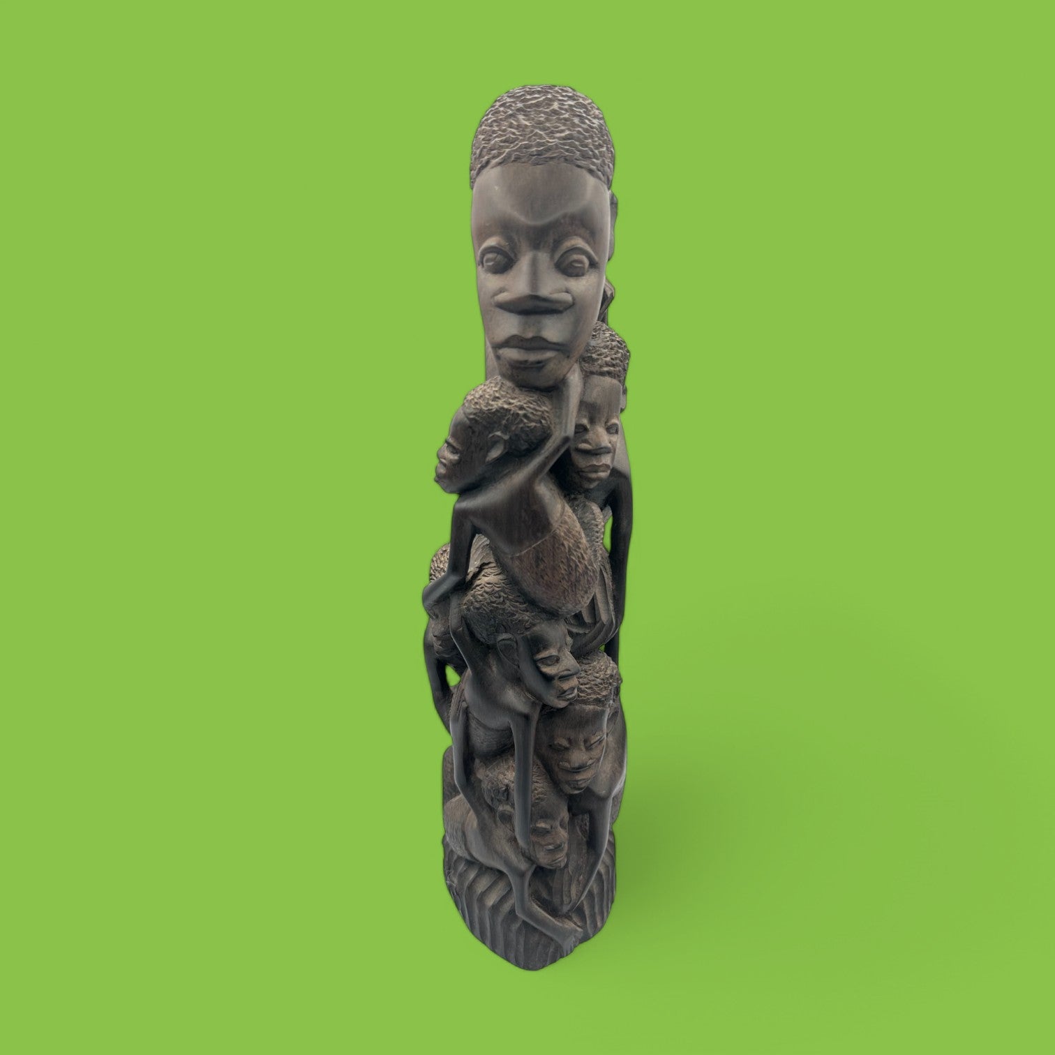 Hand-Carved African Makonde Family Tree Sculpture / Carving Ebony Art showcases intricate, stacked faces symbolizing generations.
