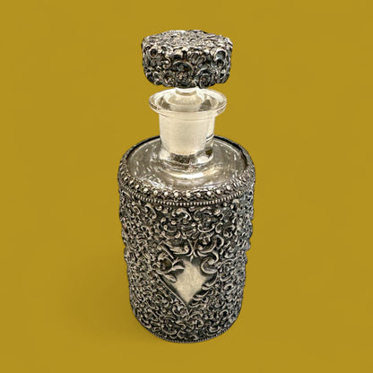 Antique ornate metal filigree perfume bottle with stopper