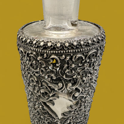 Antique ornate metal filigree perfume bottle with stopper
