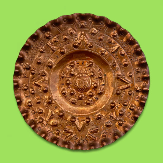 Vintage round copper plate with Aztec sun god design