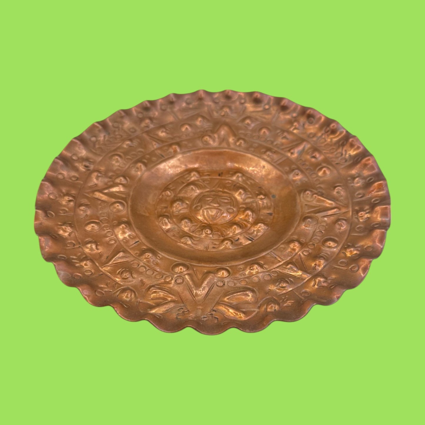 Vintage round copper plate with Aztec sun god design